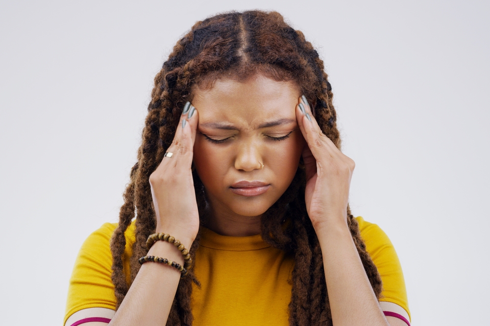 Woman, hands and headache pain in studio with stress pressure for fatigue, migraine or dehydration. Female person, temple and massage on white background or brain fog tension, anxiety or mockup space
