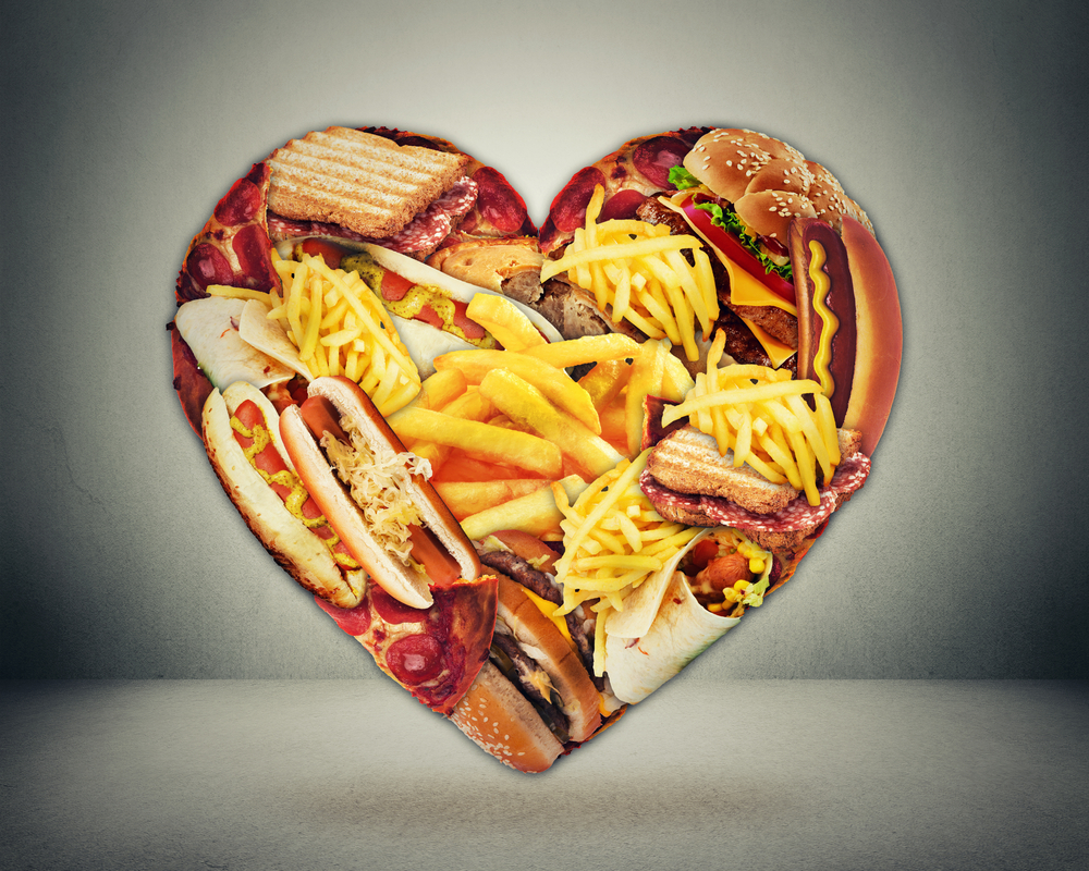 Heart health and bad diet stroke risk concept. Heart shaped of fast junk fatty food