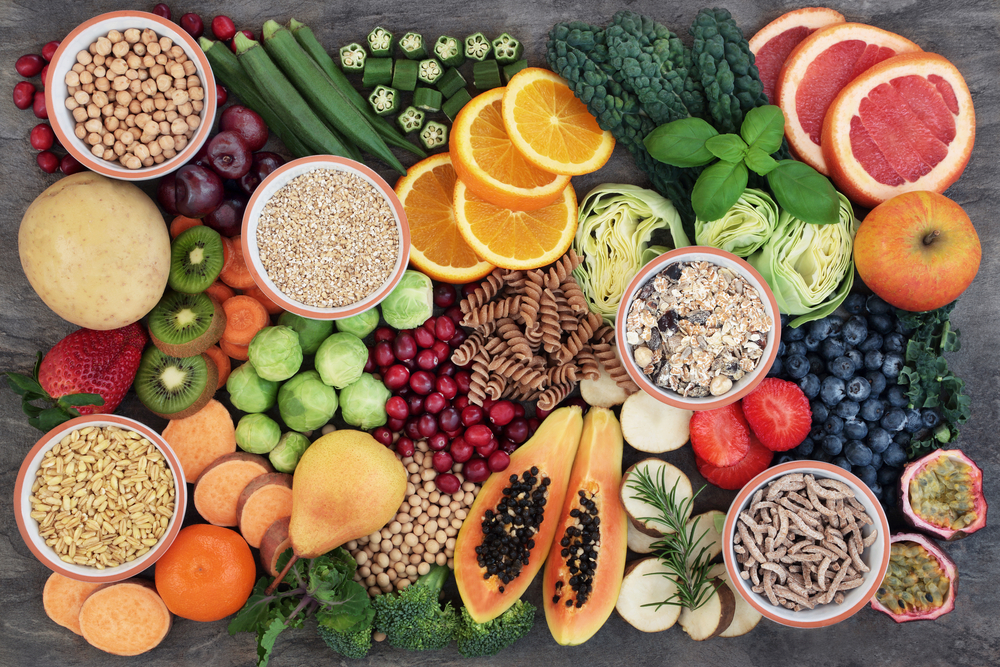 Vegan health food concept for high fibre diet with fruit, vegetables, cereals, whole wheat pasta, grains, legumes, herbs. Foods high in antioxidants and vitamins. Immune system boosting. Flat lay.