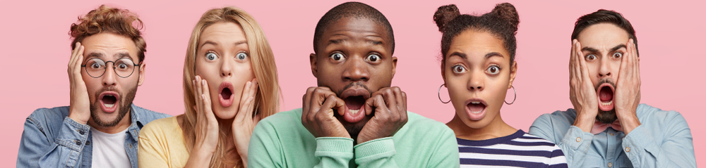 Shocked stupefied dark skinned man and their companions pose against pink background. Emotional surprised horrified mixed race people see something unexpected in front. Human reaction concept
