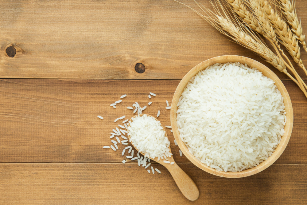 white rice (Thai Jasmine rice) in wooden bowl on wood background