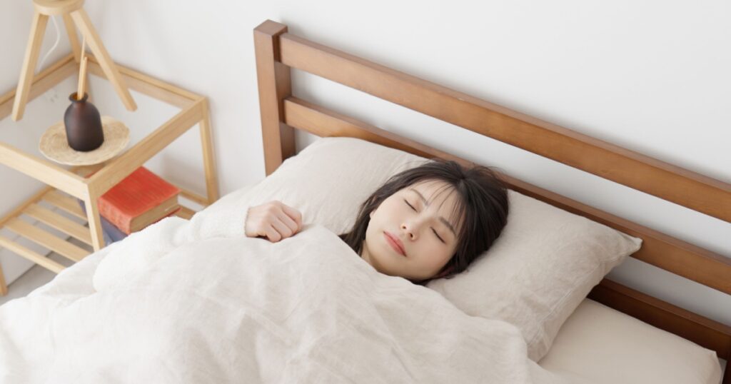 Asian woman sleeping in bed