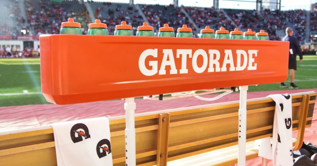 Washington D.C. - April 7, 2024: A set of Gatorade Water bottles sit on the sideline of a football game.