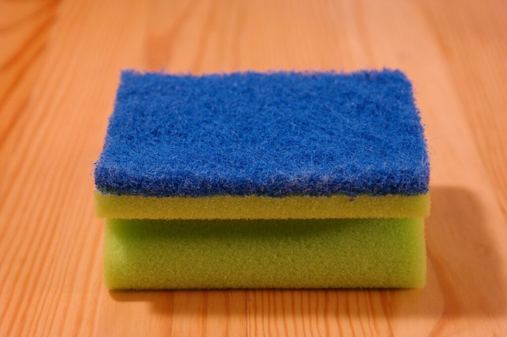 A sponge on a wooden surface. 