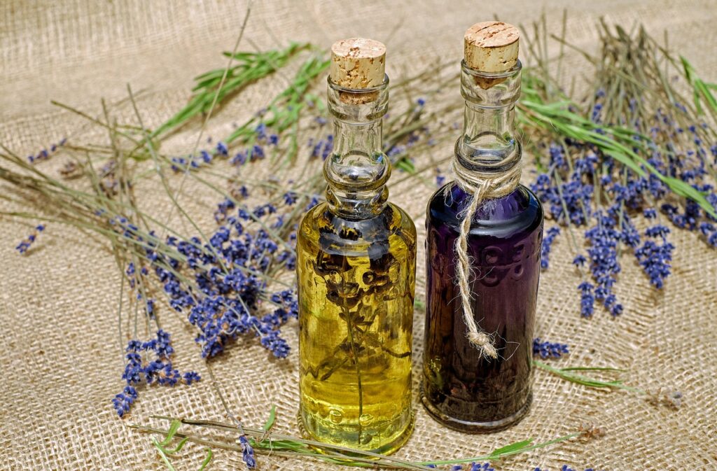 Lavender flowers with oils. Burlap in the background. 