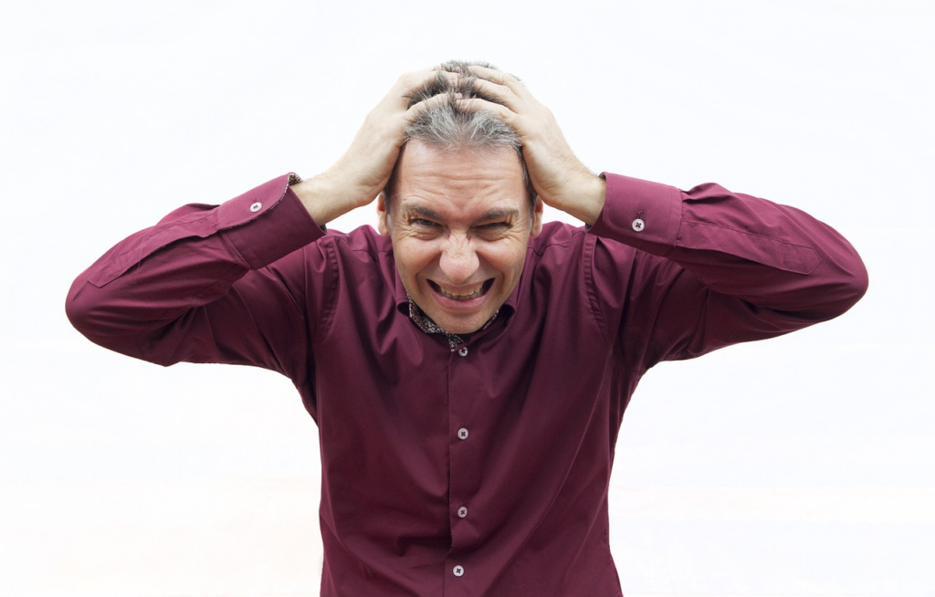 man holding his head in stress