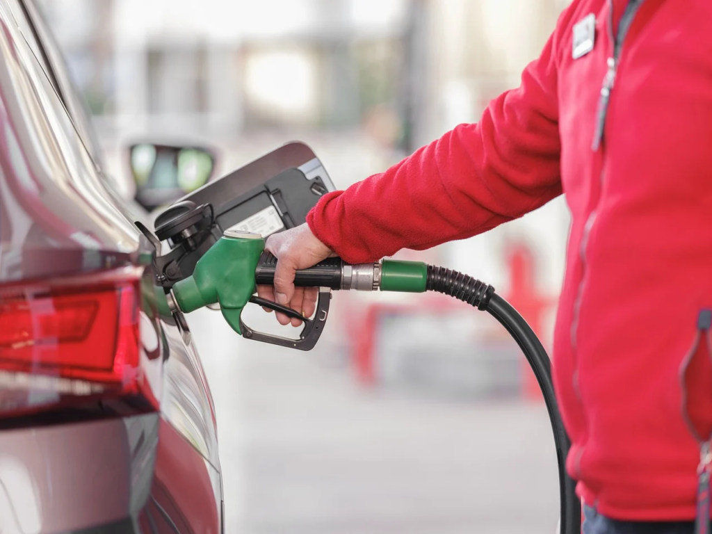 person filling up a car with gas