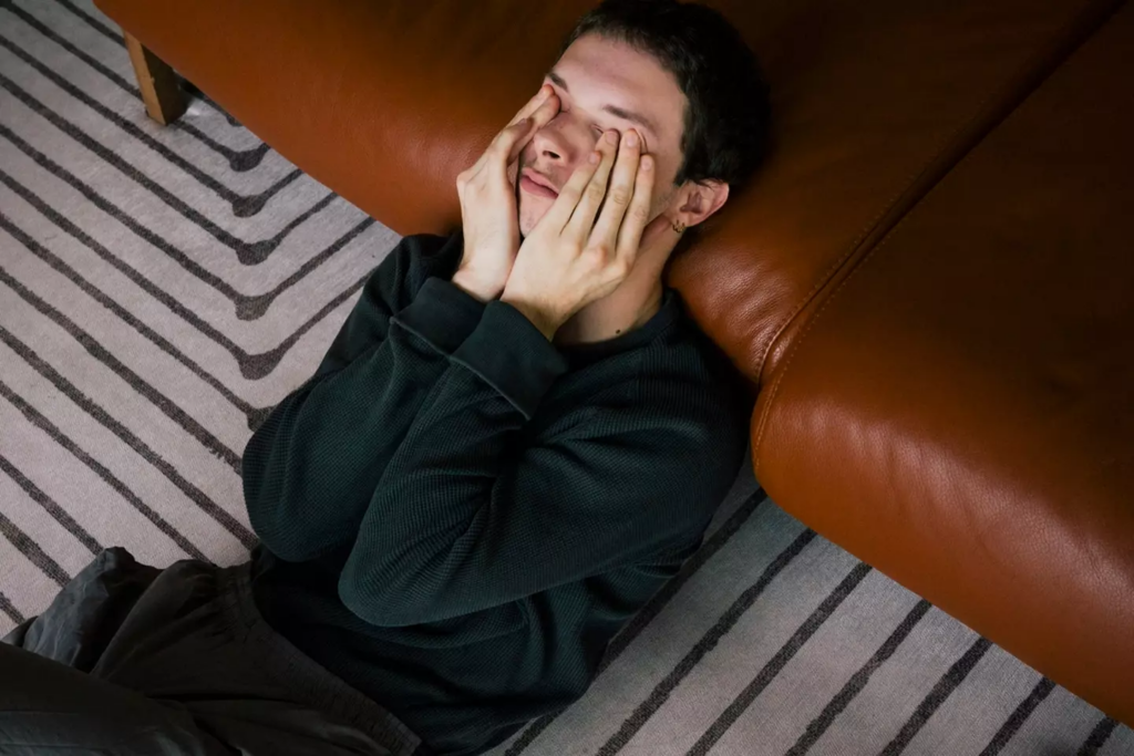 young man leaned on the couch stressed