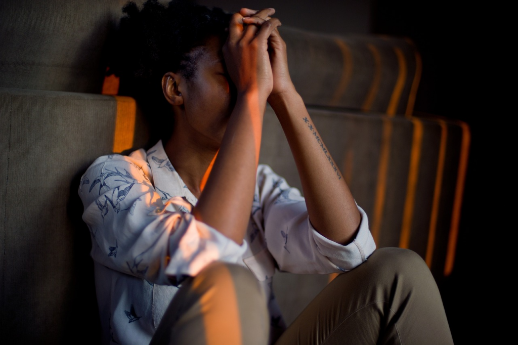 person stressed in the living room as the sun sets