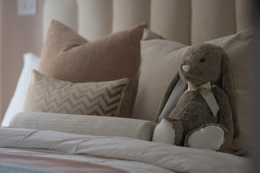 stuffed animal in bed