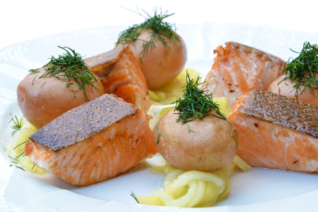 salmon pieces on pasta on a plate