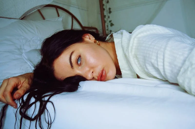 Blue-eyed woman laying on the bed