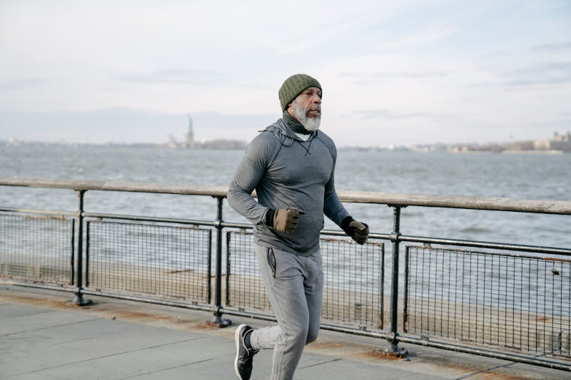man with old age running by the water