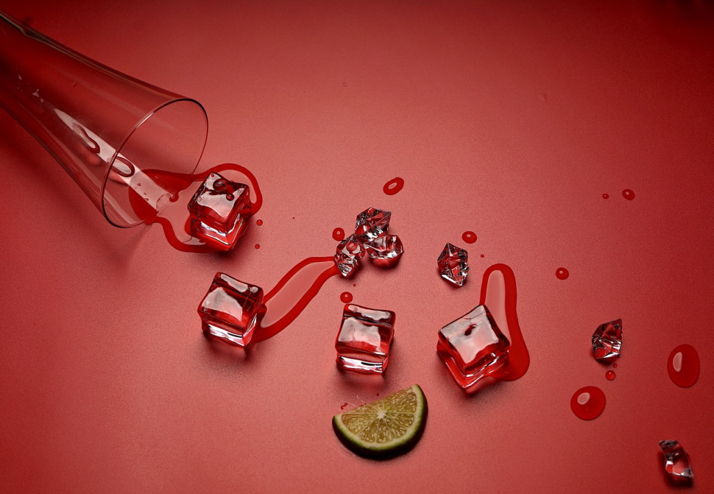 spilled ice and drink on a red background