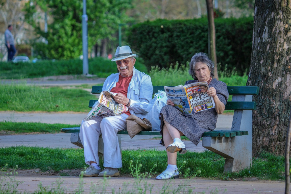 old age couple sitting and reading