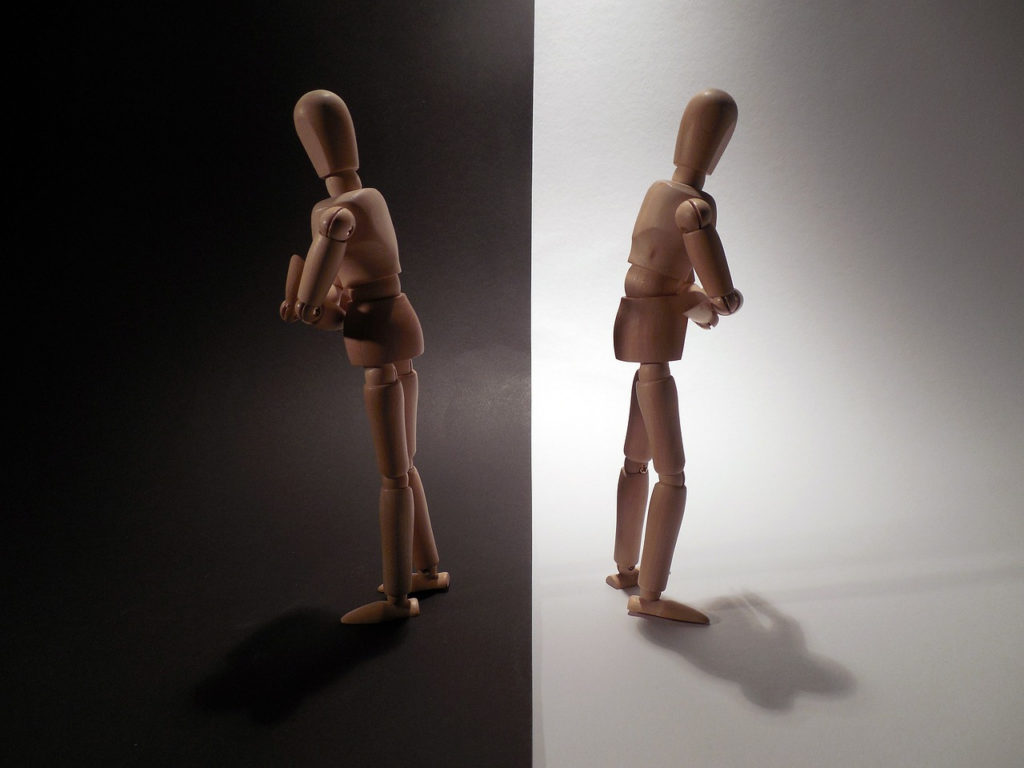 two figures in alternate backdrops facing away from each other