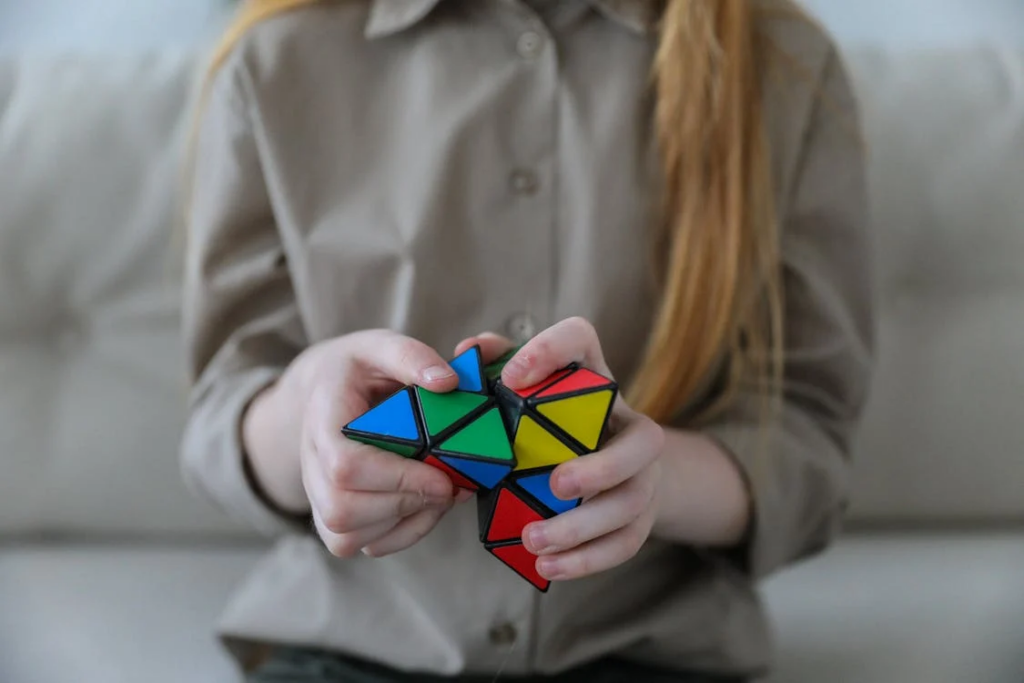 Girl showing bright brainteaser in hands
