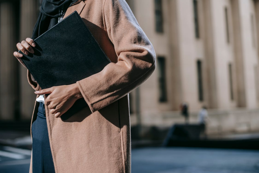 Crop woman with folder of documents
