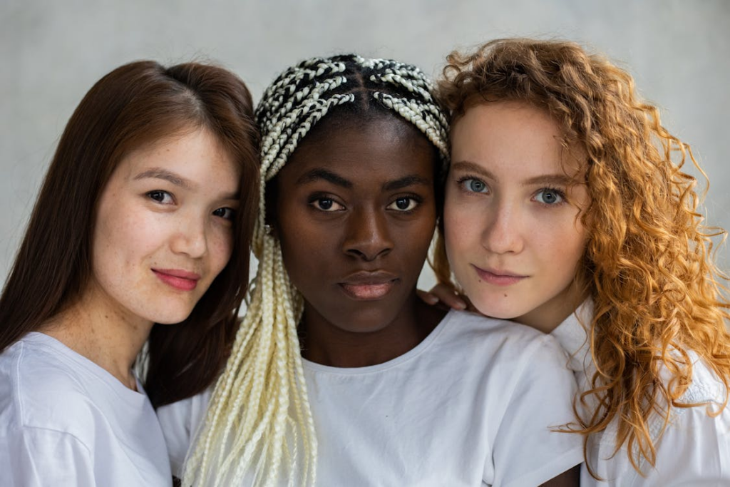 Diverse woman standing close and looking at camera
