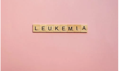 Leukemia spelt with scrabble tiles on pink background 