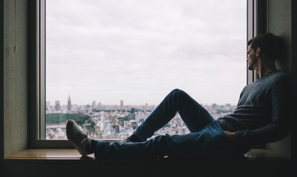 person looking out the window looking contemplative
