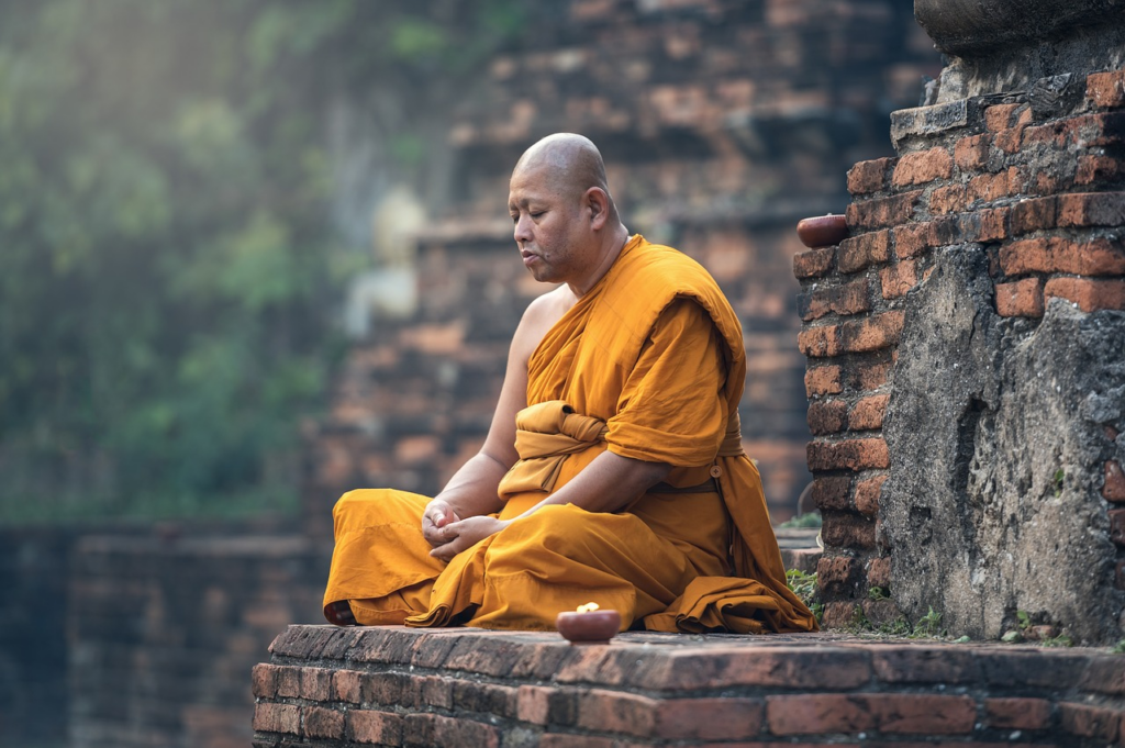 monk meditating on a ledge