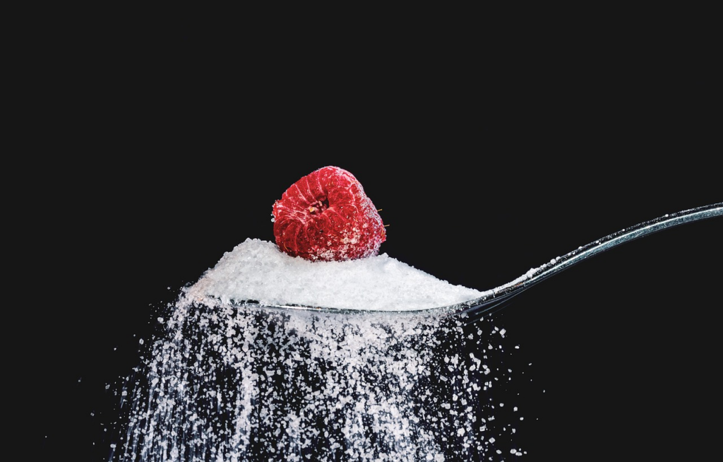 raspberry on sugar in a spoon