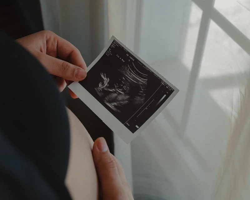woman looking at ultrasound photos