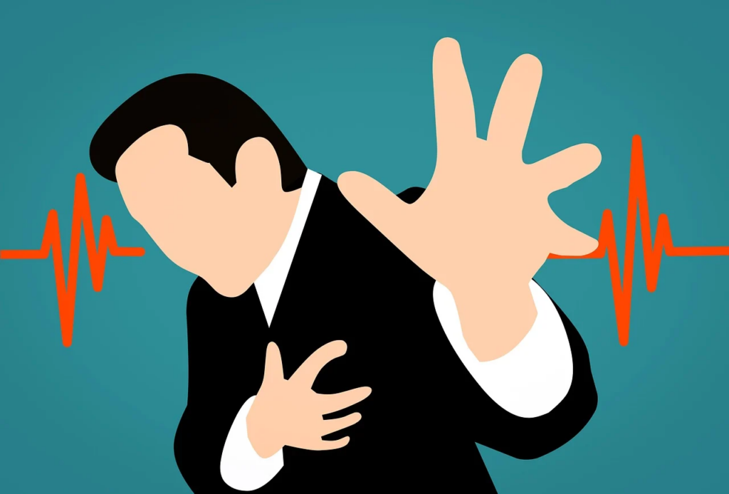 man grabbing his heart with a heartbeat monitor reading behind him
