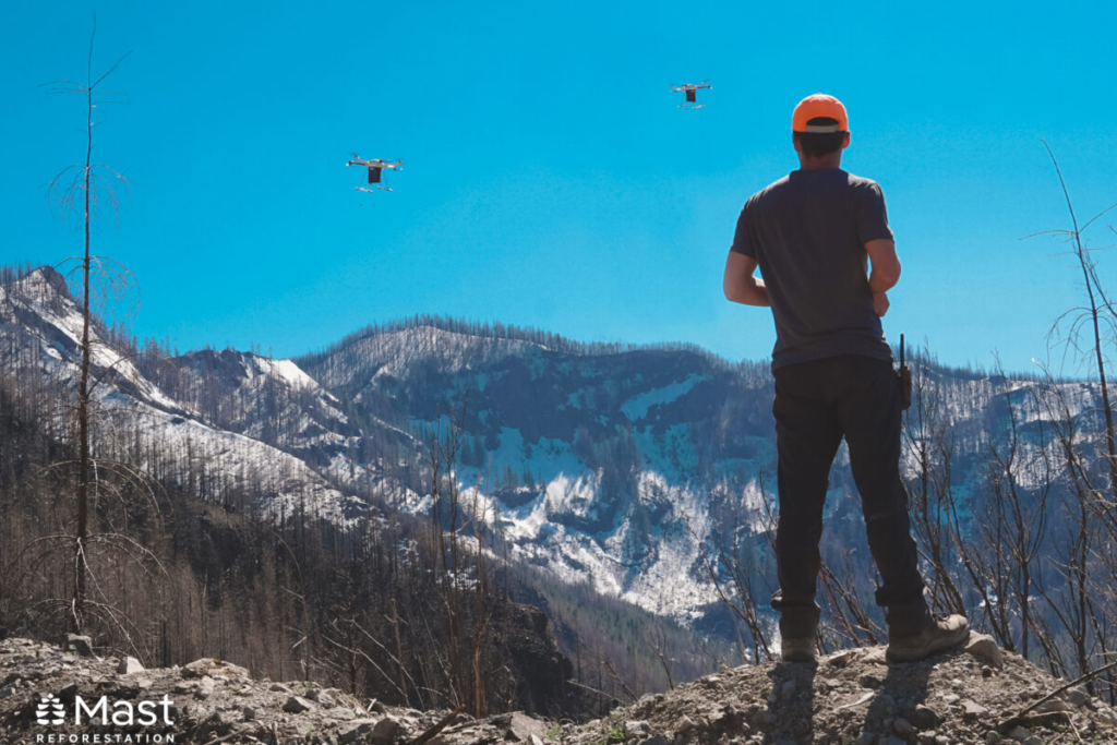 Mast Reforestation drones in flight over conifer forests in the U.S. West