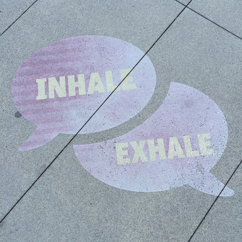 inhale and exhale written on concrete