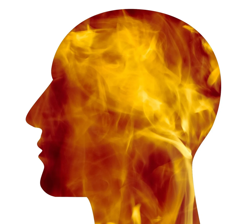 sillhouette of person with fire burning inside