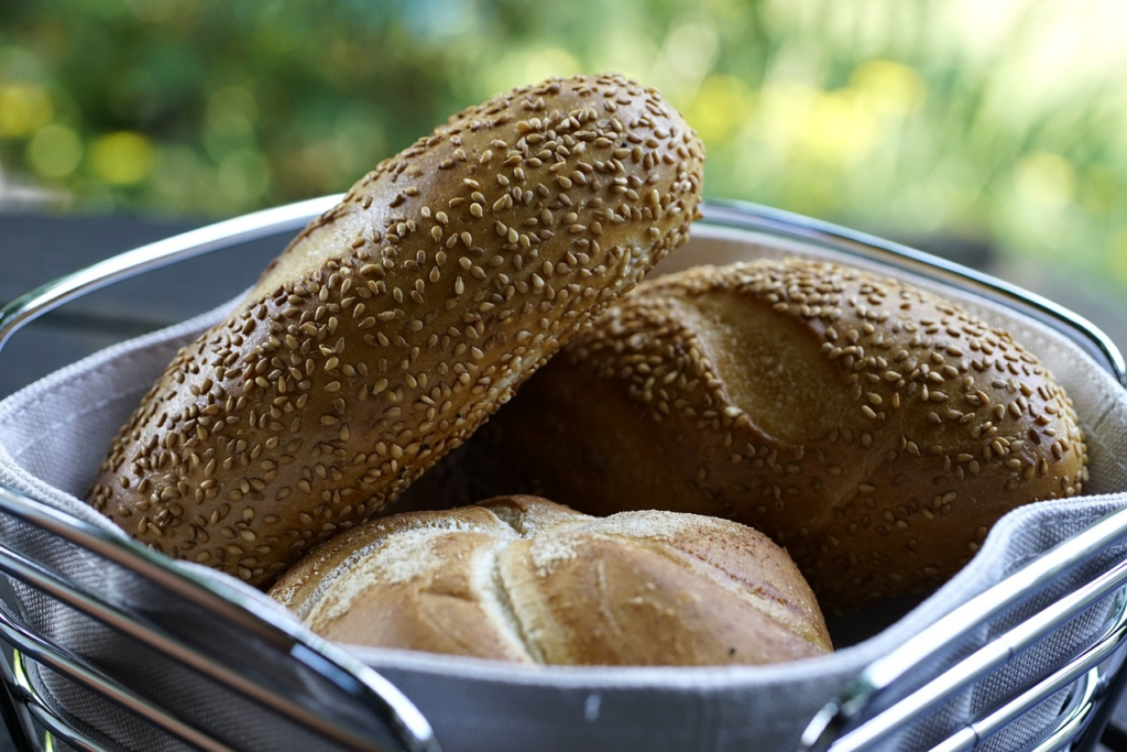 assorted breads with sesame seeds on them