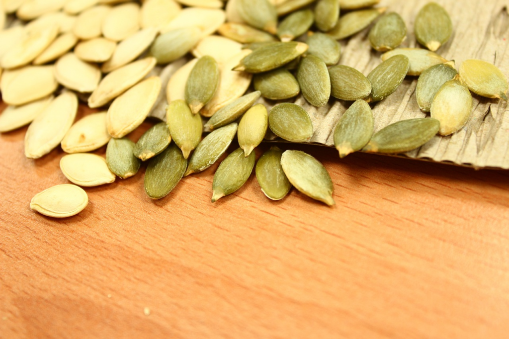 pumpkin seeds spilling off onto a table