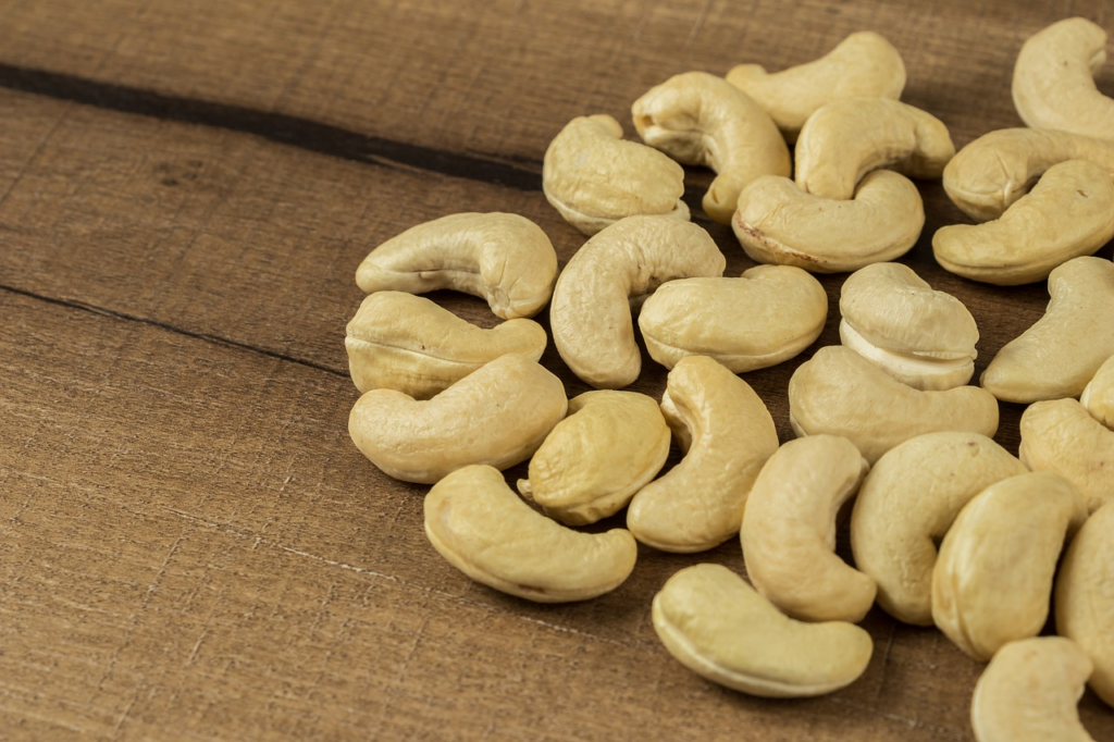 raw cashews on a wood table