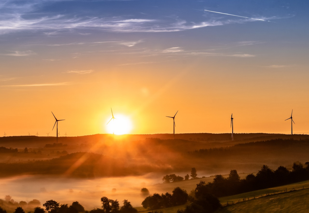 wind turbines on a hill at sunrise