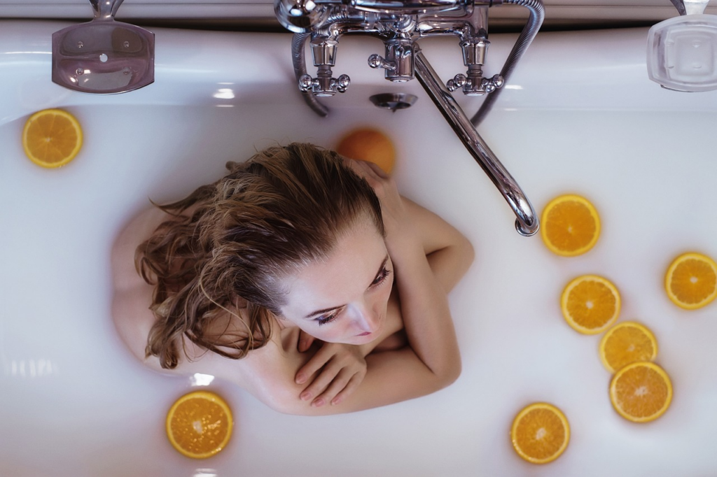 woman with her arms crossed in a milky bath