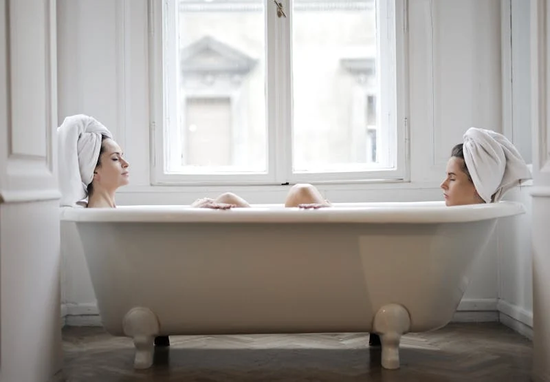 women in a bathtub relaxing