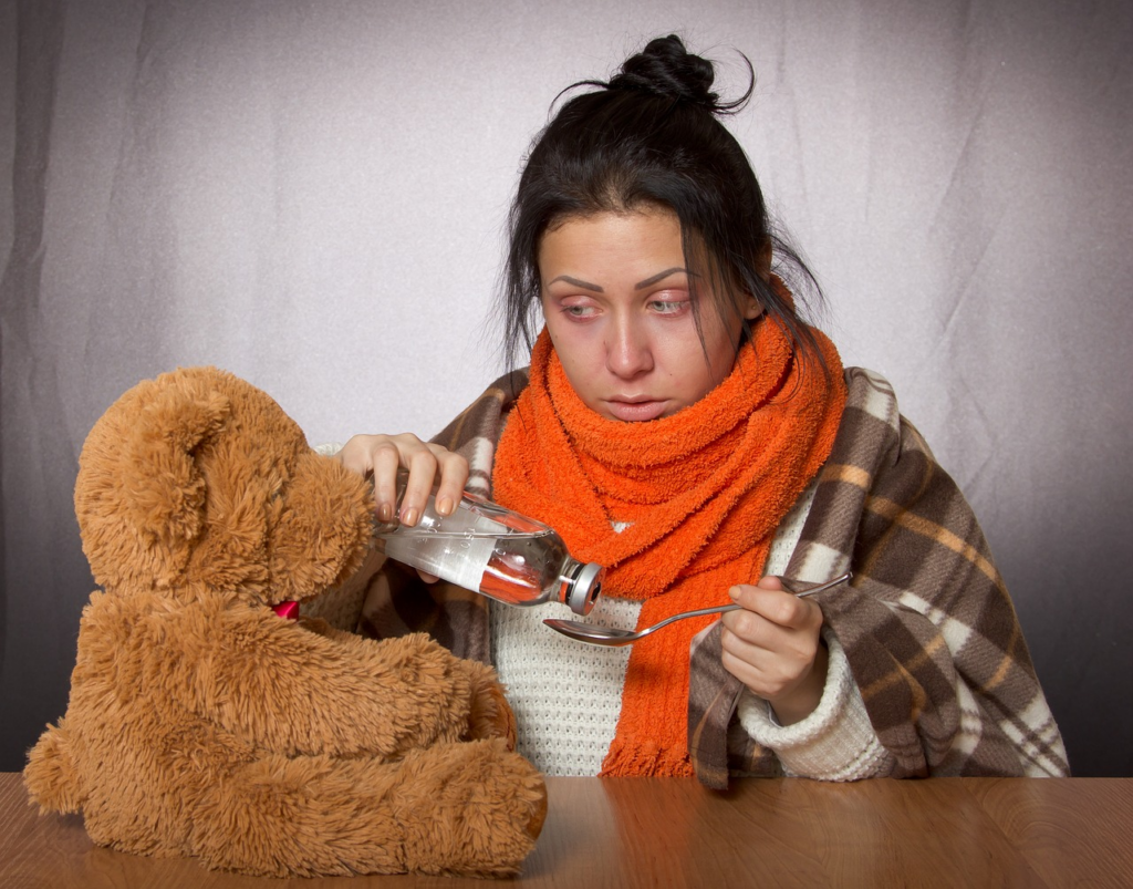 woman with the flu with her teddy
