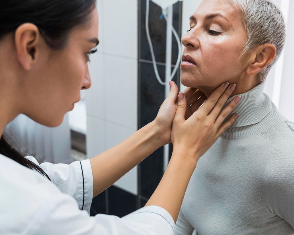 doctor examining lymph nodes of patient 