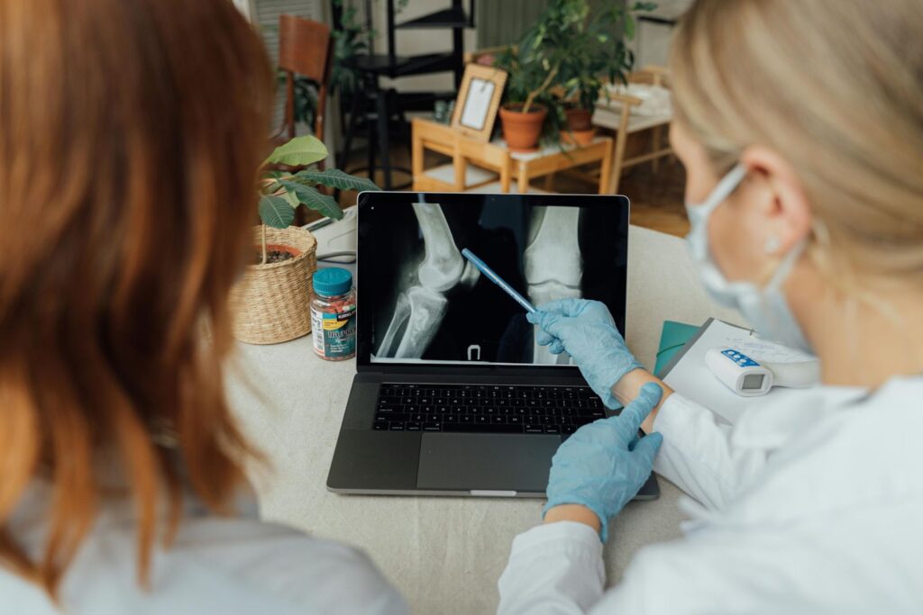 doctor discussing a patients x-ray with them 