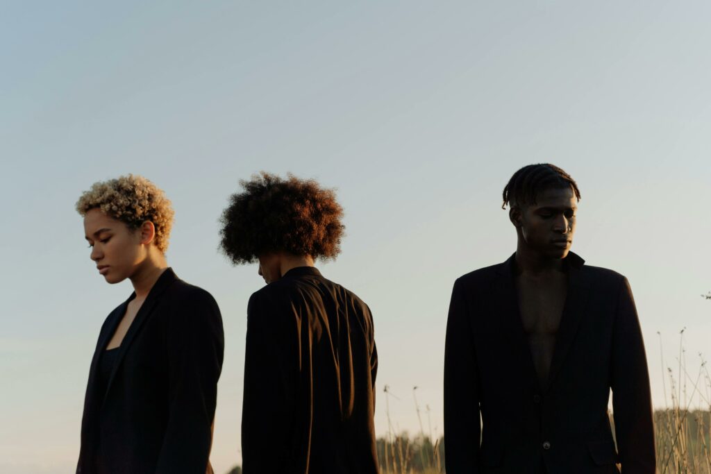 People Wearing Black Clothes Under Blue Sky
