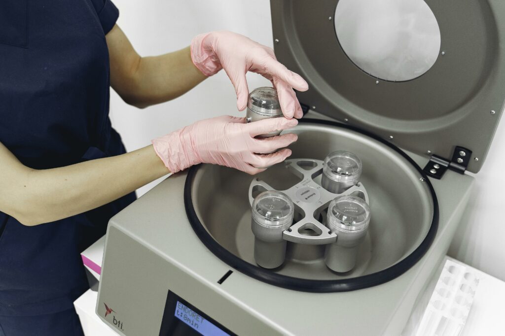  taking test tube out of centrifuge for plasma in modern clinic

