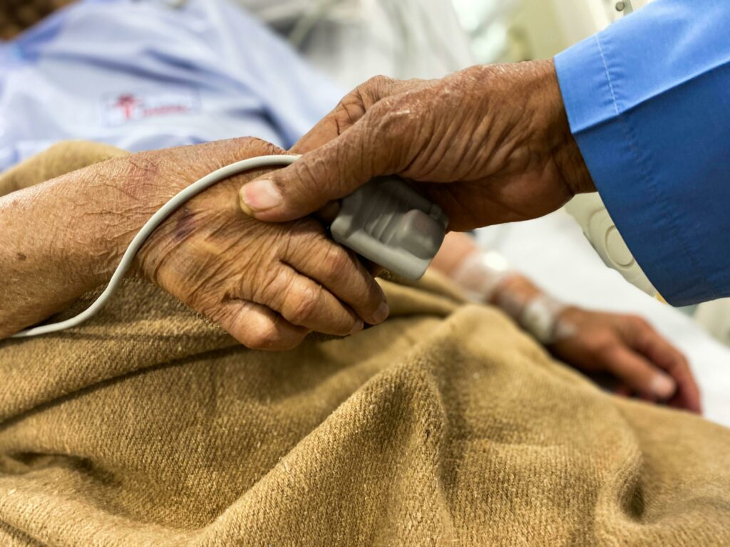 Old couple holding hands in hospital
