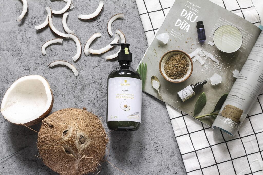 A coconut with coconut oil products. A magazine and gray and checkered background.