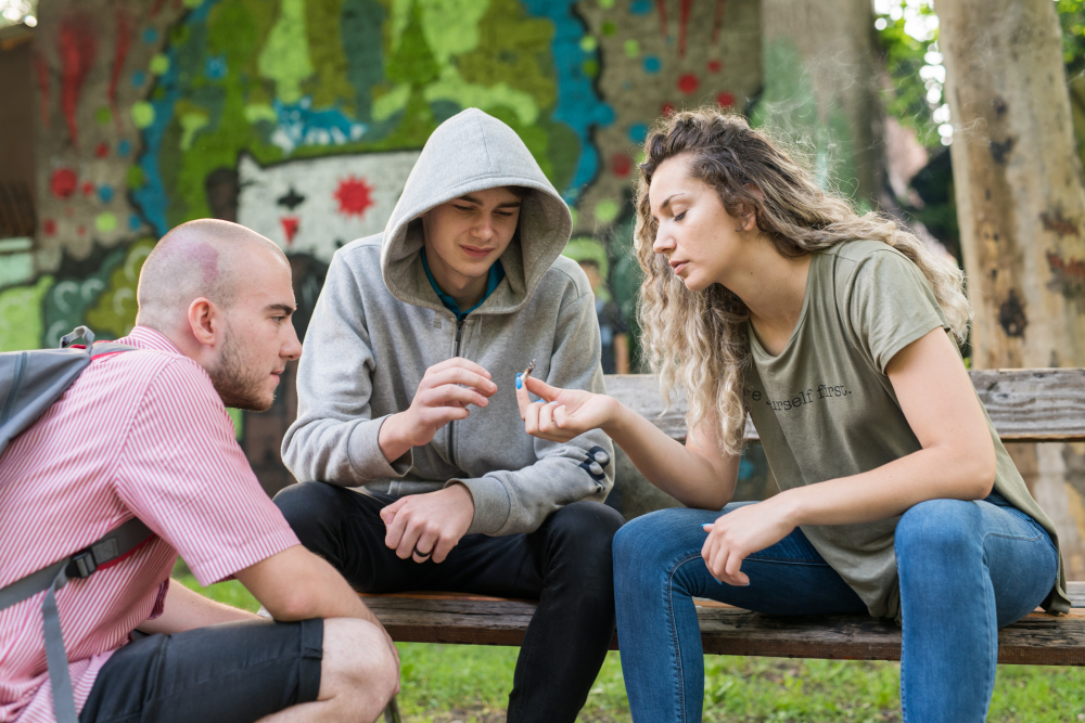 Friends smoking weed in the park.
