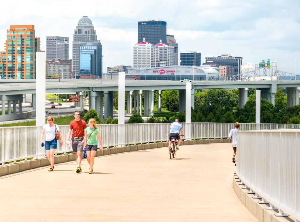 LOUISVILLE, KENTUCKY:  JULY 3, 2018 - People travel to walk and bike on public space by the Big Four Bridge shared urban path in downtown park of Louisville, Kentucky