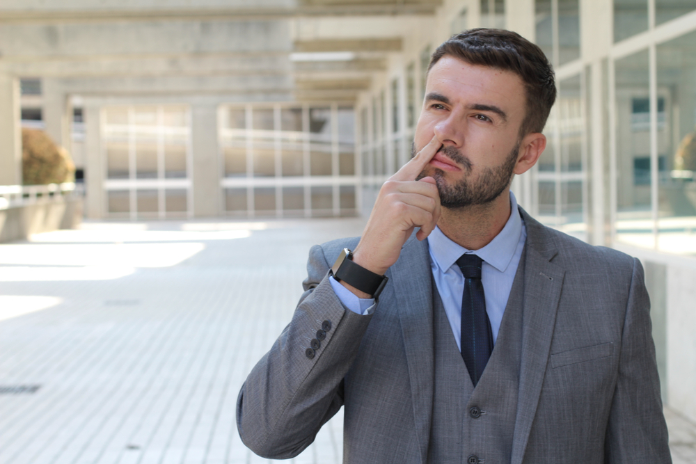 Busy businessman finding some mucus 