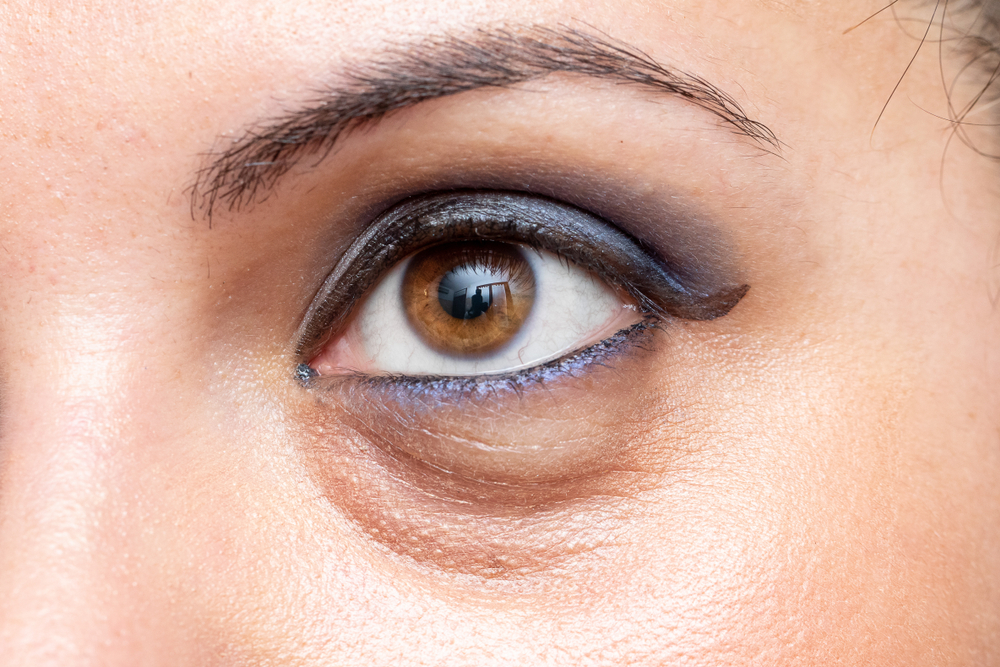 A macro view on the open eye of a young Caucasian woman, showing
