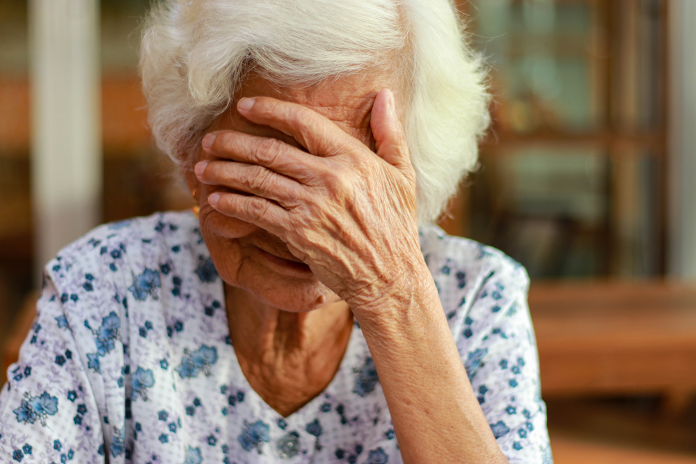 Asian woman with white hair shows signs of memory impairment. Health problems and treatment costs.